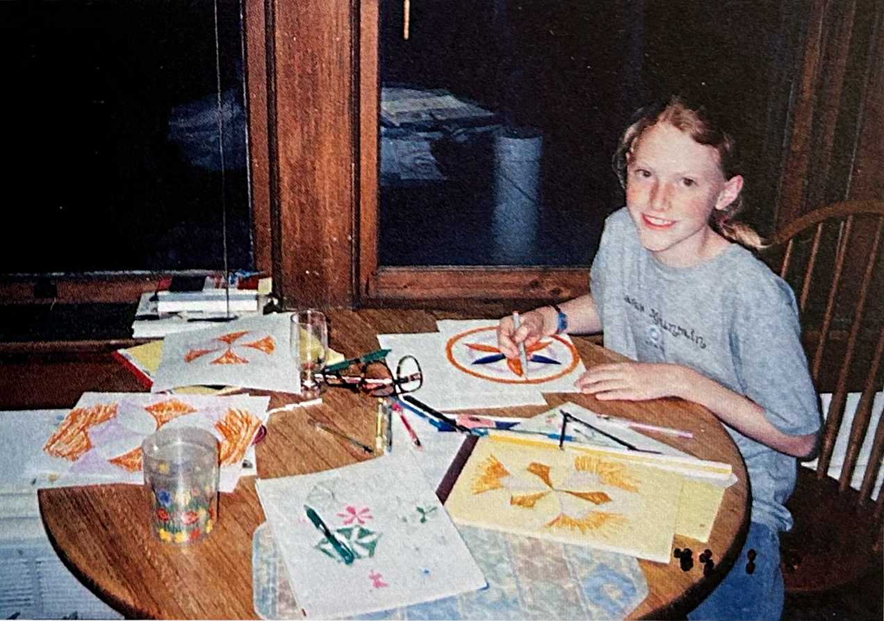Anna in her kitchen studio working on garden designs